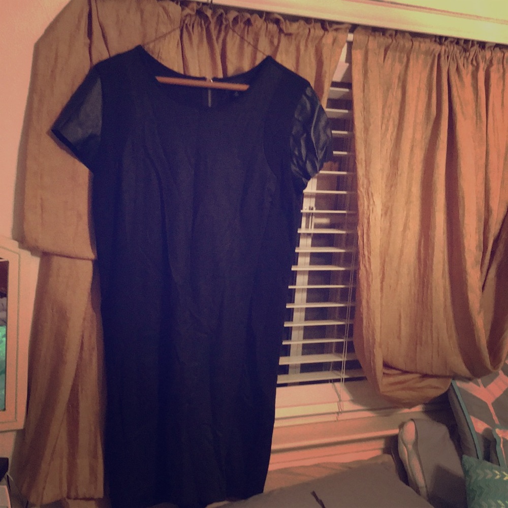 Black dress with faux leather sleeves.